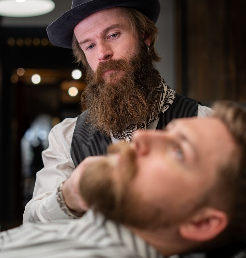 Client relaxing in a barber chair getting a haircut